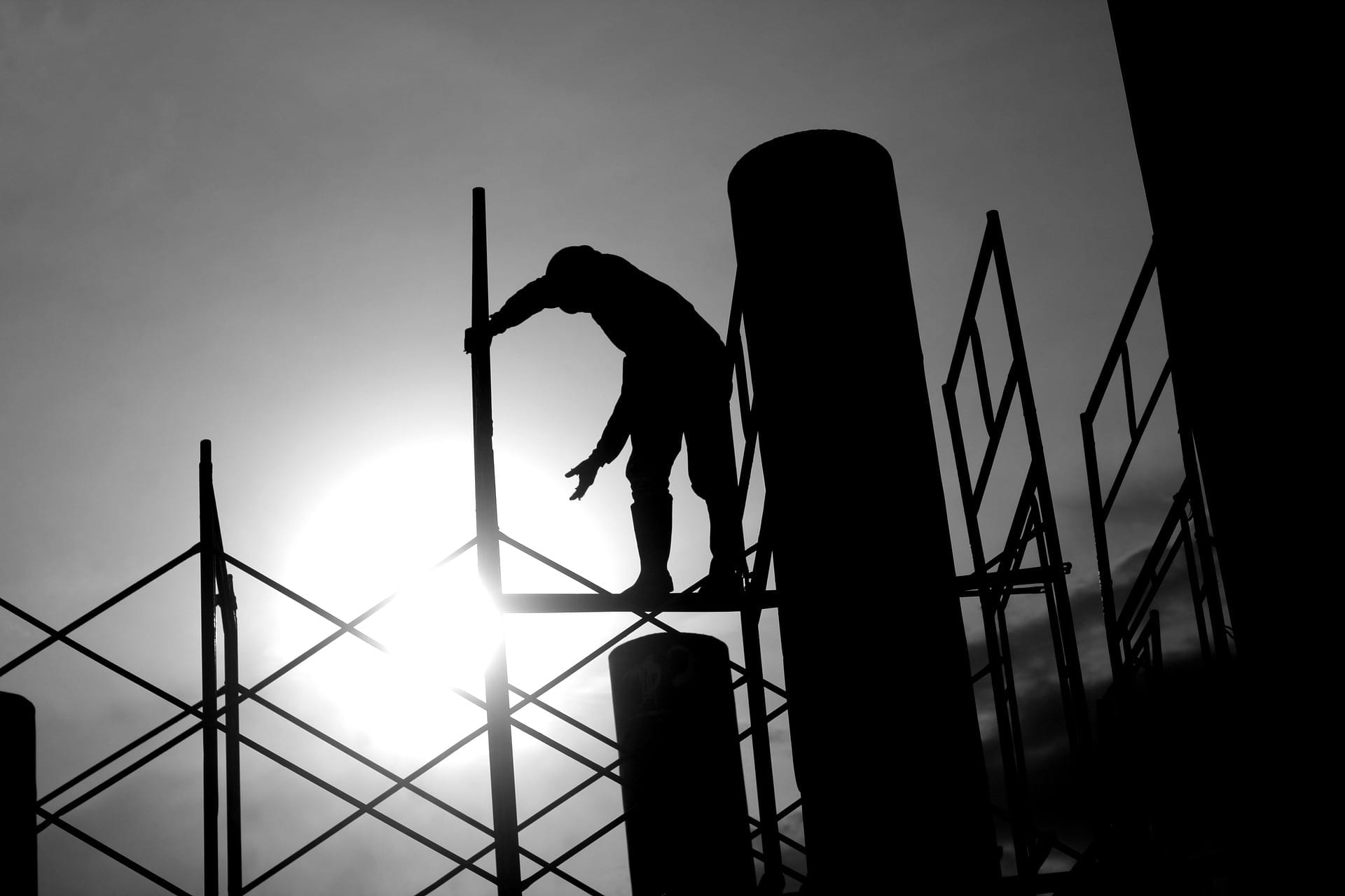 silhouette of construction worker on a scaffold