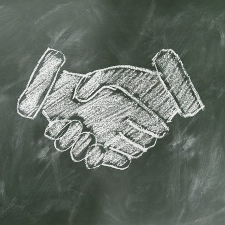 drawing on a chalk board of shaking hands