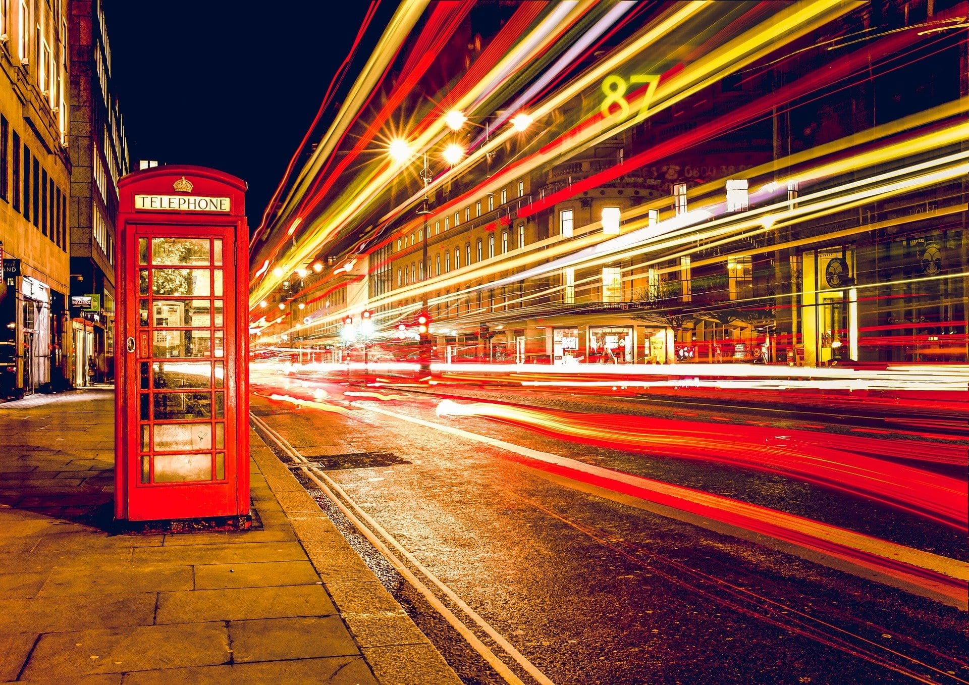 commercial street at night with telephone booth